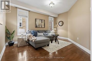 Oshawa (Taunton) apartment for rent - A living room with a grey couch and a wooden floor.