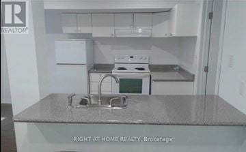 Richmond Hill (Westbrook) townhouse for rent - A kitchen with a stove top oven and a sink.