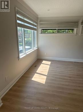 Mississauga (Clarkson) apartment for rent - A room with wooden flooring and a window with blinds.