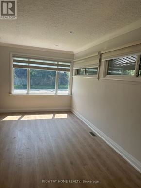 Mississauga (Clarkson) apartment for rent - A room with a window and wooden flooring.