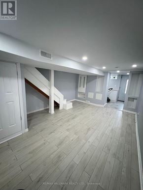 Toronto (Annex) apartment for rent - A spacious room with wooden flooring and white walls.