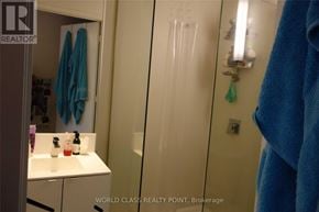 Toronto (Waterfront Communities) condo for rent - A bathroom with a white sink and a blue towel hanging on the door.