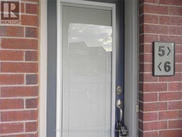Mississauga (Erin Mills) townhouse for rent - A door with a glass window and a sign on the wall.