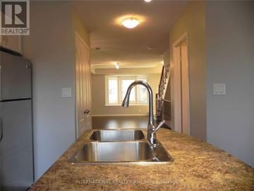 Mississauga (Erin Mills) townhouse for rent - A kitchen with a granite countertop and stainless steel sink.