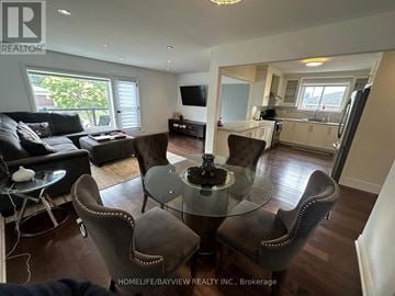 Toronto (Victoria Village) apartment for rent - A living room with a glass table and brown chairs.