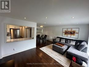 Toronto (Victoria Village) apartment for rent - A living room with a grey couch and a painting on the wall.