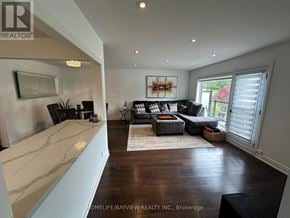 Toronto (Victoria Village) apartment for rent - A living room with a white marble counter top and a large window with blinds.