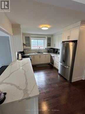 Toronto (Victoria Village) apartment for rent - A kitchen with a refrigerator, sink, and cabinets.