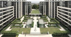 Markham (Unionville) condo for rent - A courtyard surrounded by buildings with a fountain in the middle.