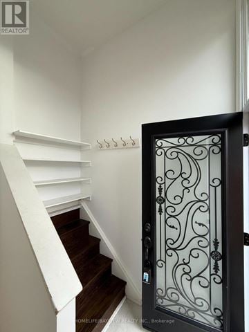 Toronto (Victoria Village) apartment for rent - A black wrought iron door with a decorative design.
