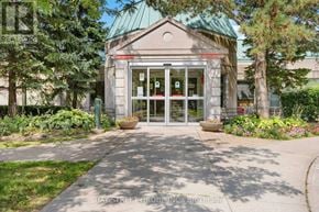 Toronto (Agincourt North) condo for rent - The front of a building with a glass door and a green roof.