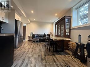 Markham (Grandview) apartment for rent - A kitchen with a refrigerator, a dining table with chairs, and a countertop.