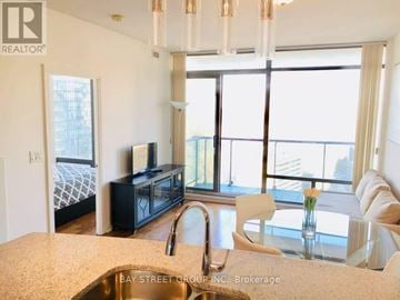 Toronto (Annex) condo for rent - A kitchen with a sink and a window overlooking the city.
