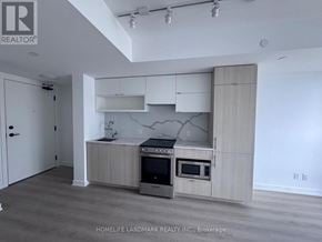 Toronto (Church-Yonge Corridor) condo for rent - A kitchen with a stove top oven and microwave built into a cabinet.
