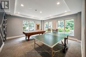 Toronto (St. Andrew-Windfields) condo for rent - A spacious room with a ping pong table and a view of the backyard.