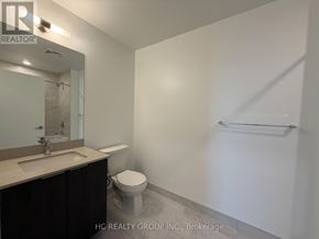 Mississauga (City Centre) condo for rent - A bathroom with a toilet, sink, and mirror.