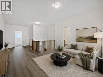 Cambridge townhouse for rent - A well-lit, modern living room with a white sofa and a coffee table.