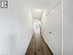 Cambridge townhouse for rent - A long hallway with white walls and wood flooring.