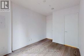 Toronto (Church-Yonge Corridor) condo for rent - A room with white walls and wooden flooring, with a door on the right side.