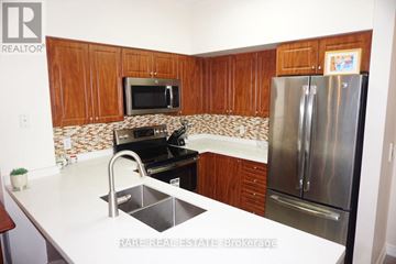Toronto (Waterfront Communities) condo for rent - A kitchen with a refrigerator, sink, and microwave.