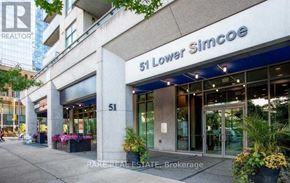 Toronto (Waterfront Communities) condo for rent - The front of a building with the number 51 and the words "Lower Simcoe" on it.