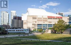 Toronto (Waterfront Communities) condo for rent - Rogers Centre is a large white building with a red sign on it.