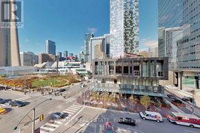 Toronto (Waterfront Communities) condo for rent - A city street with a FedEx truck and a real estate brokerage office.