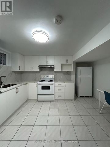 Toronto (Agincourt North) apartment for rent - A white kitchen with a stove top oven and a refrigerator.