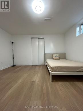 Toronto (Agincourt North) apartment for rent - A bedroom with a bed, a door, and a window.