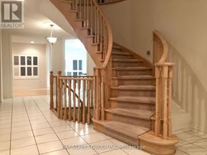 Markham (Cachet) apartment for rent - A wooden staircase with a carpeted runner leads up to a bright room with a window.