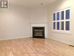 Markham (Cachet) apartment for rent - A room with a fireplace and a window with blinds.