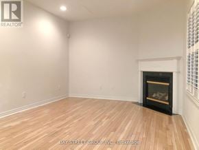 Markham (Cachet) apartment for rent - A room with a fireplace and wooden flooring.