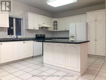 Markham (Cachet) apartment for rent - A kitchen with white cabinets and a black countertop.