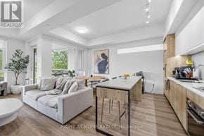 Toronto (Yorkdale-Glen Park) condo for rent - A modern kitchen with wooden cabinets and a breakfast bar.