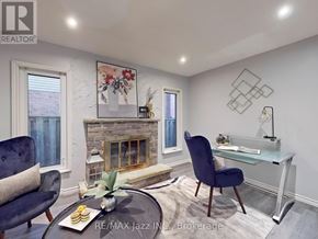 Oshawa (Donevan) apartment for rent - A living room with a fireplace, a blue chair, and a coffee table.