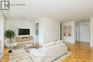 Toronto (Thorncliffe Park) condo for rent - A living room with a white couch and a television.