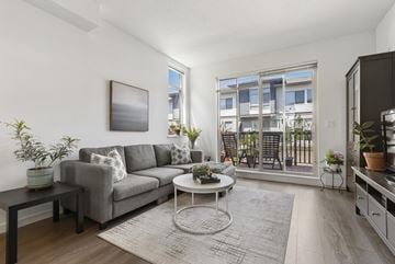 Surrey townhouse for rent - A living room with a grey couch, a coffee table, and a painting on the wall.