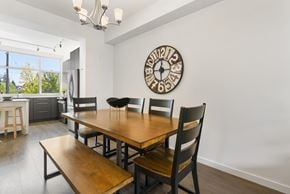 Surrey townhouse for rent - A dining room with a wooden table and chairs.