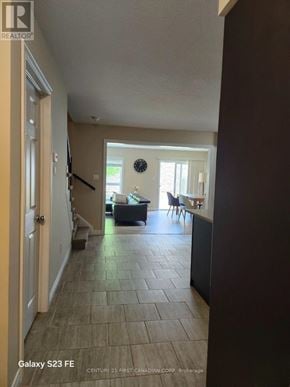 London South (South B) townhouse for rent - A hallway with a tiled floor and a door on the left.