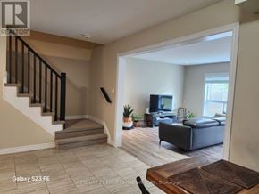 London South (South B) townhouse for rent - A living room with a couch, a television, and a fireplace.