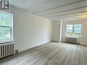 Ottawa multi-family for rent - A white room with a window and a door.
