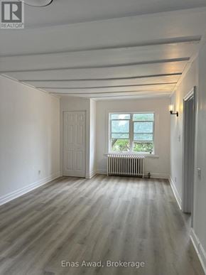 Ottawa multi-family for rent - A room with a window and a radiator on the wall.