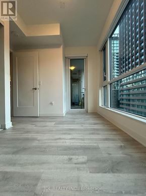 Toronto (Waterfront Communities) condo for rent - A spacious room with a doorway leading to another room.