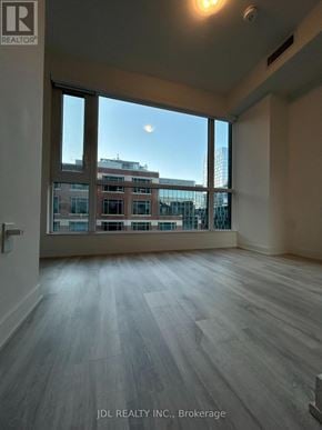 Toronto (Waterfront Communities) condo for rent - A room with a view of a cityscape through large windows.