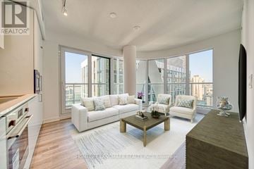 Toronto (Kensington-Chinatown) condo for rent - A living room with a white couch and a coffee table.