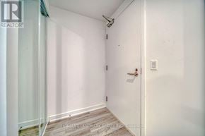 Toronto (Kensington-Chinatown) condo for rent - A white door with a handle and a light switch on the wall.