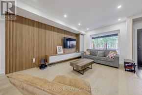 Toronto (Palmerston-Little Italy) apartment for rent - A living room with a flat screen TV and a grey couch.