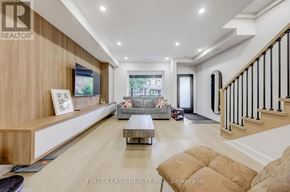 Toronto (Palmerston-Little Italy) apartment for rent - A spacious living room with a staircase on the right side.