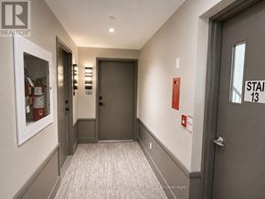 Oakville (Ro River Oaks) condo for rent - A hallway with a carpeted floor and a door on the right.