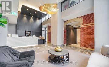 Toronto (East End-Danforth) condo for rent - A modern living room with a grey sofa and a coffee table.